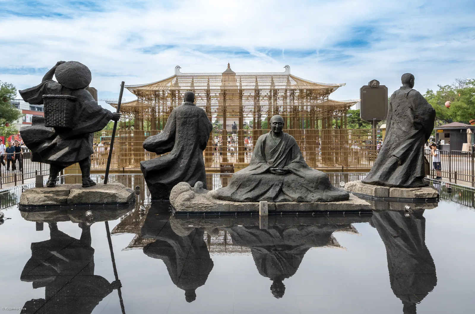 Bronze Tang-era figures and a reflecting pool on the Datang Everbright City boulevard