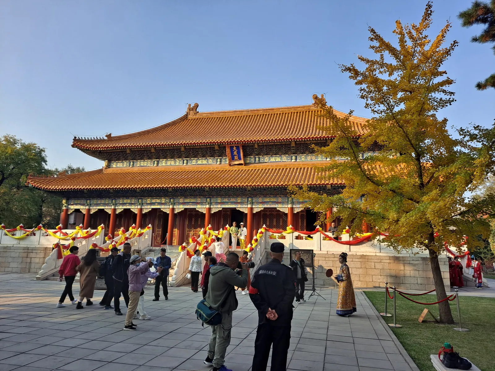Dacheng Hall of Harbin Confucius Temple with an autumn ginkgo tree