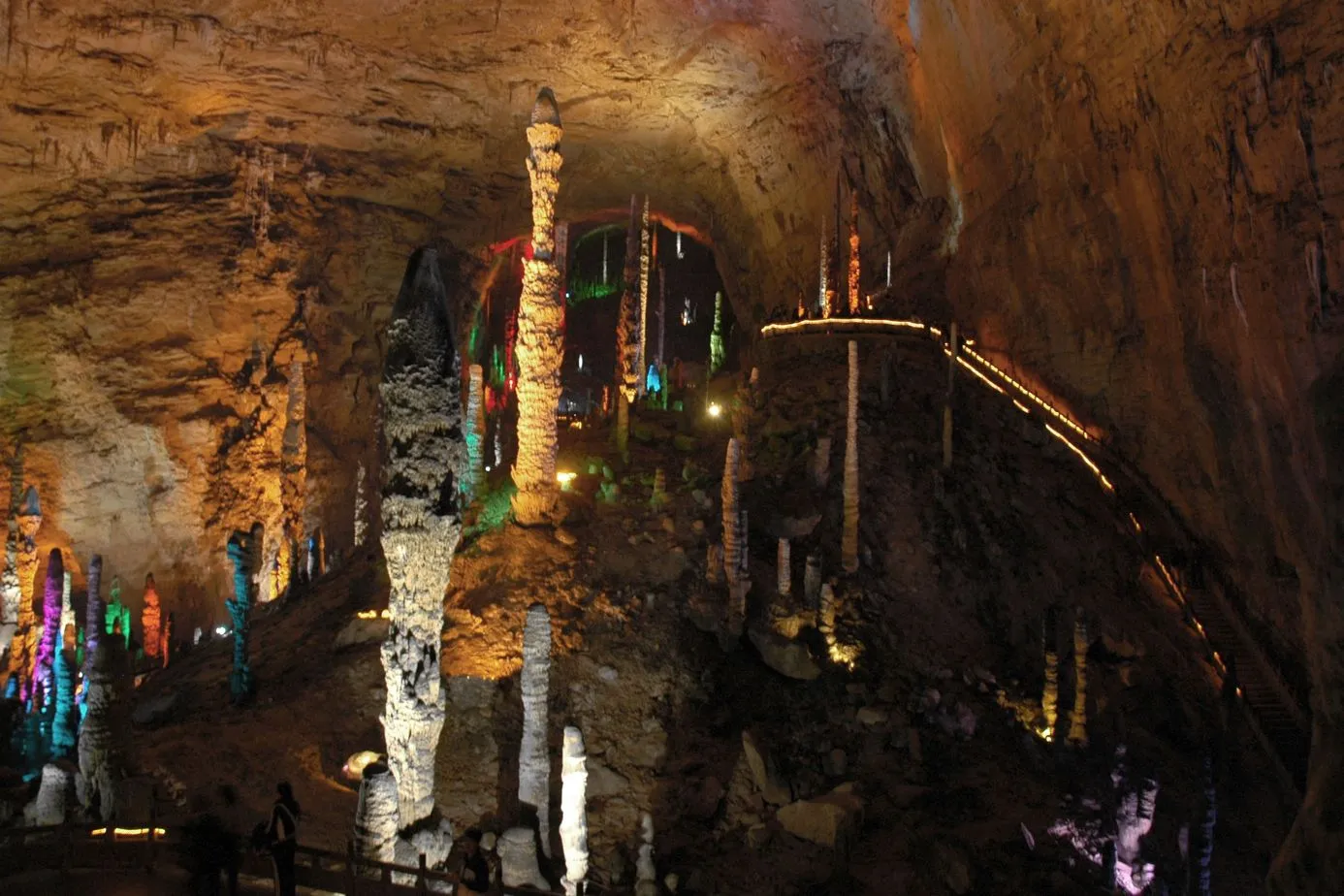 Lit stalagmites and a walkway inside Yellow Dragon Cave
