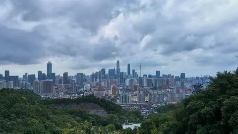 Guangzhou's skyline seen over forest from Baiyun Mountain