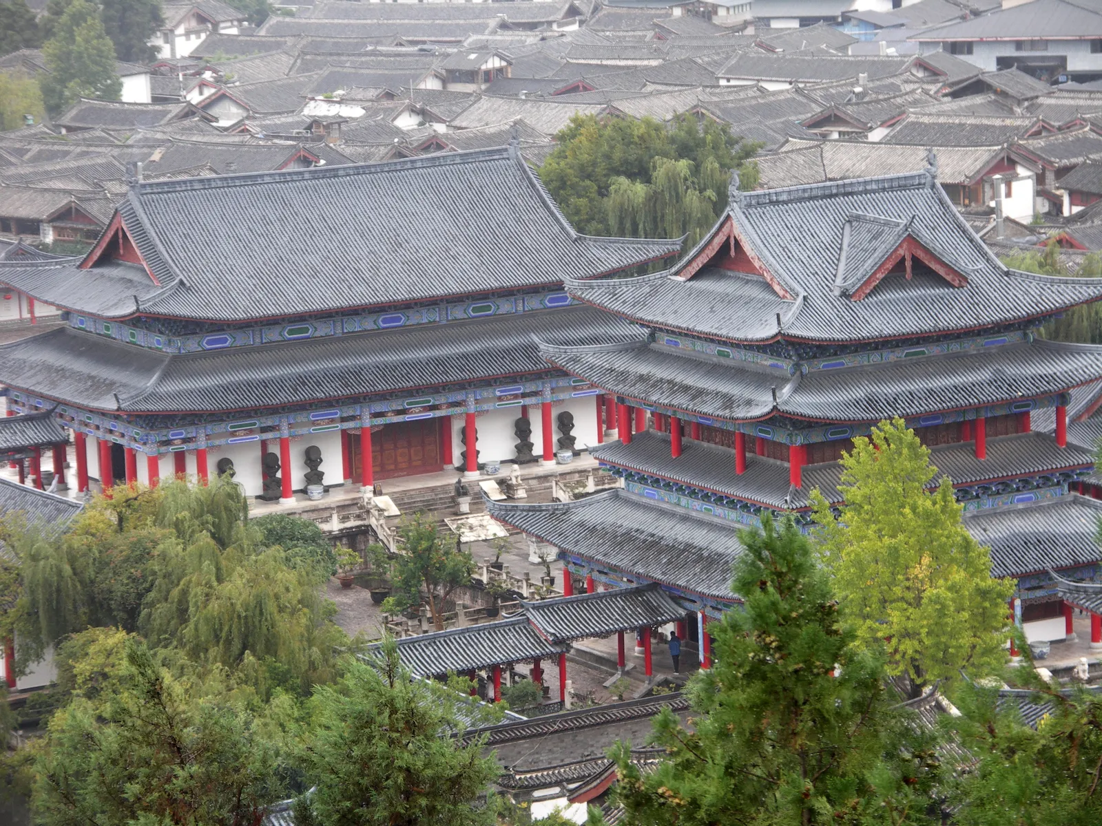 Halls of the Mu Palace rising above Lijiang Old Town's rooftops