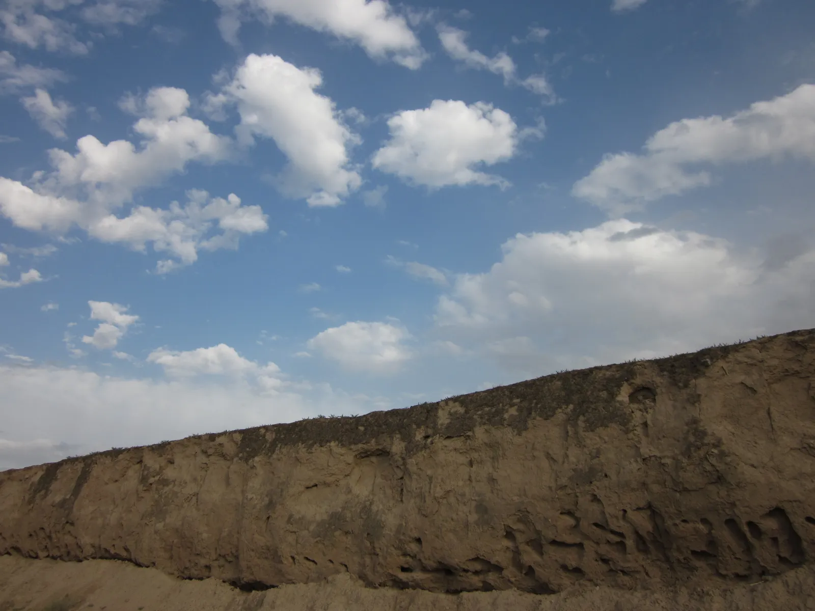 Weathered rammed-earth Ming Great Wall north of Shandan town