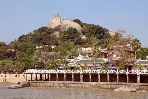 Sunlight Rock rising above the trees and seafront of Gulangyu