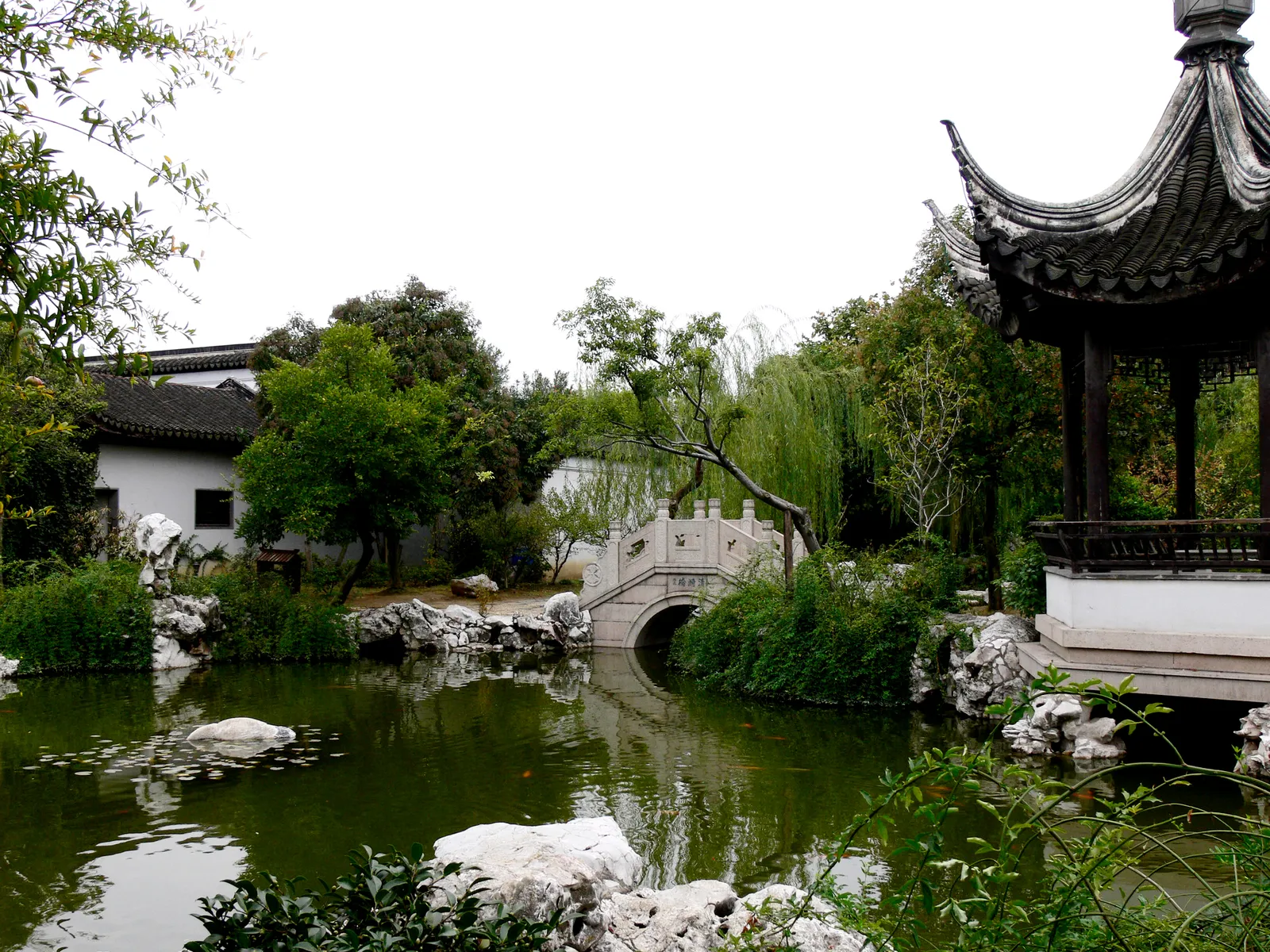 Pond, pavilion and arched bridge in the Yan Family Garden, Mudu