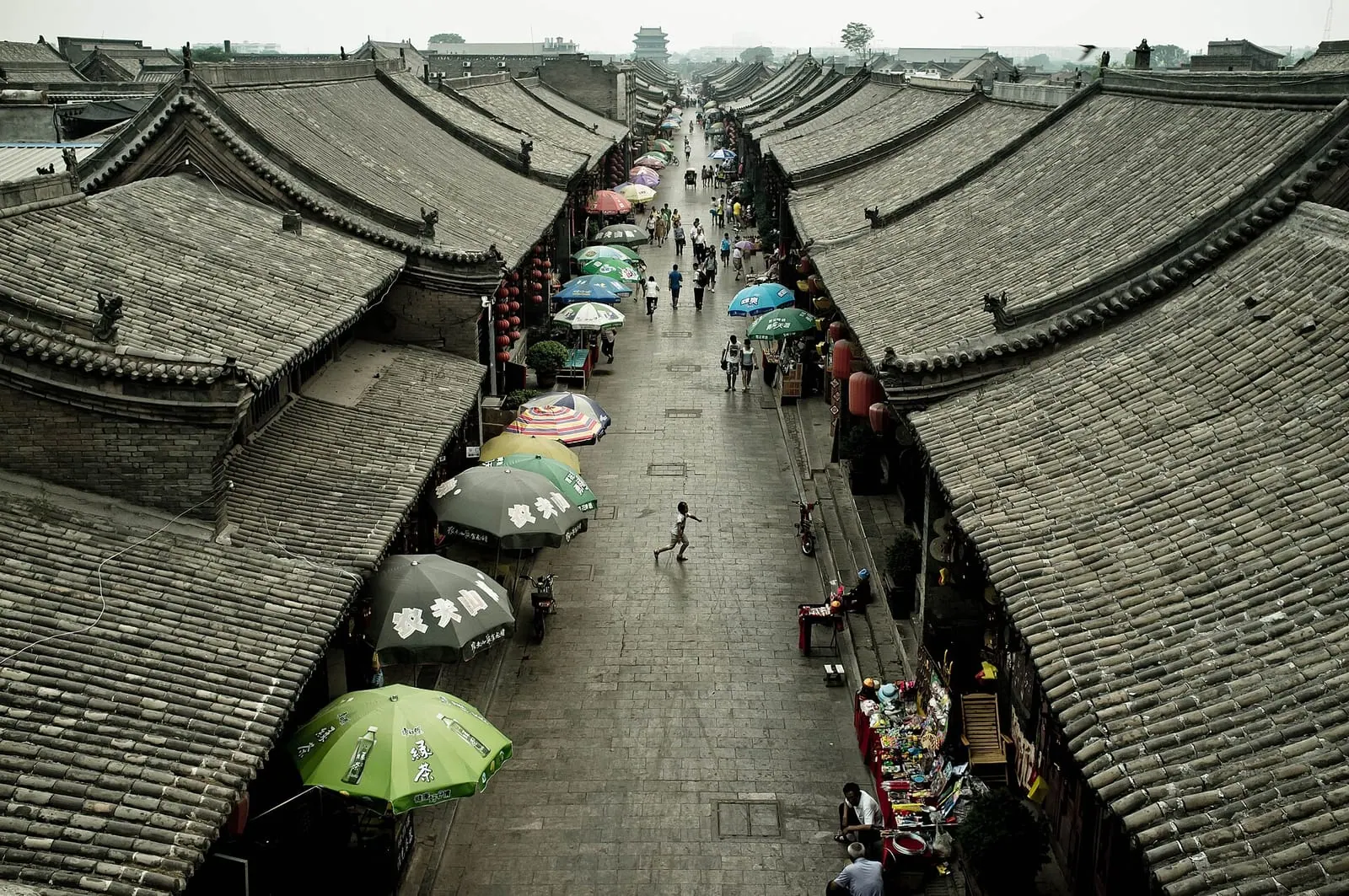 Grey-tiled rooftops along a market street in Pingyao Ancient City